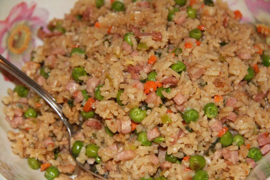 Delicious rice dish featuring peas, ham, and vegetables, perfect for a hearty meal.