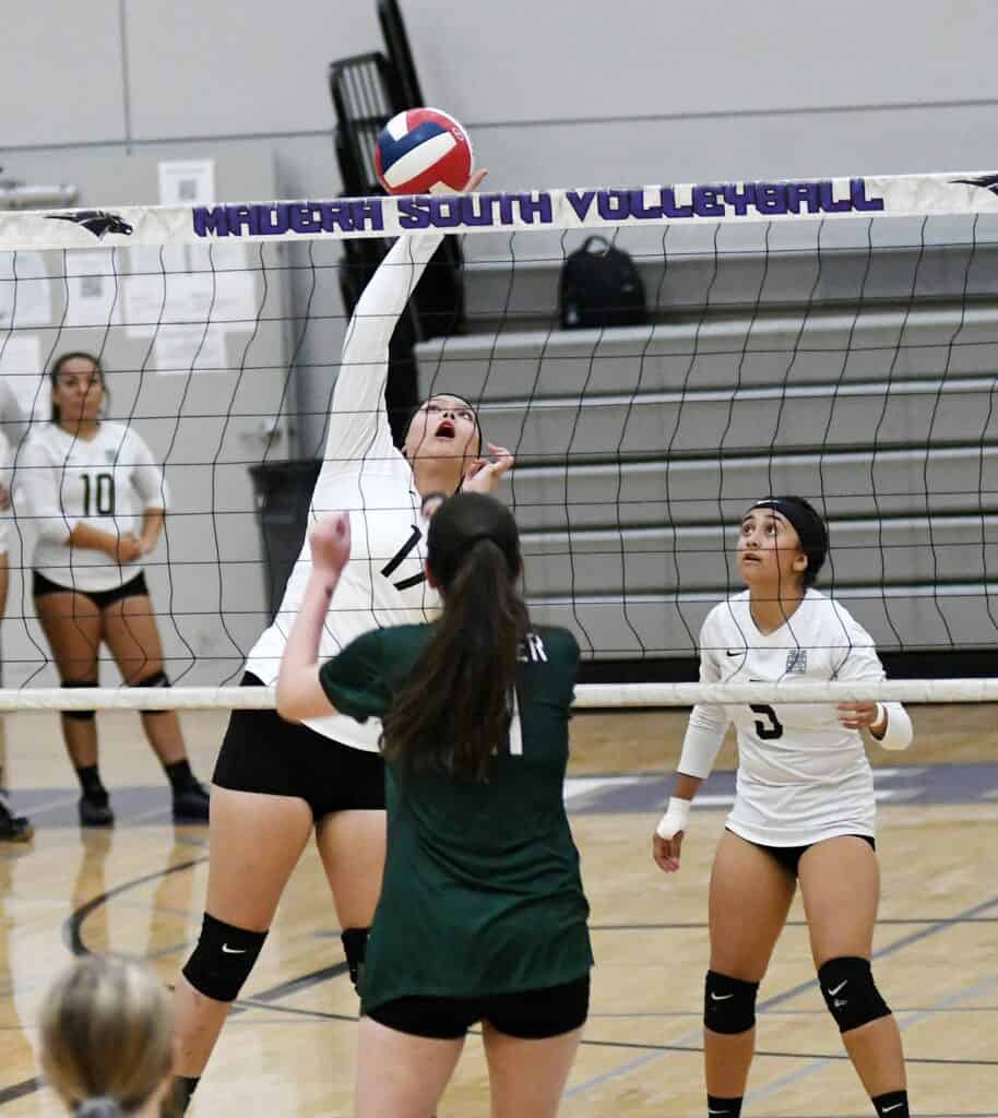 Madera South volleyball player spikes the ball during a match.