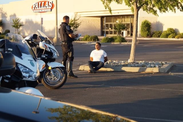 Police officer talking to man after stunt incident.