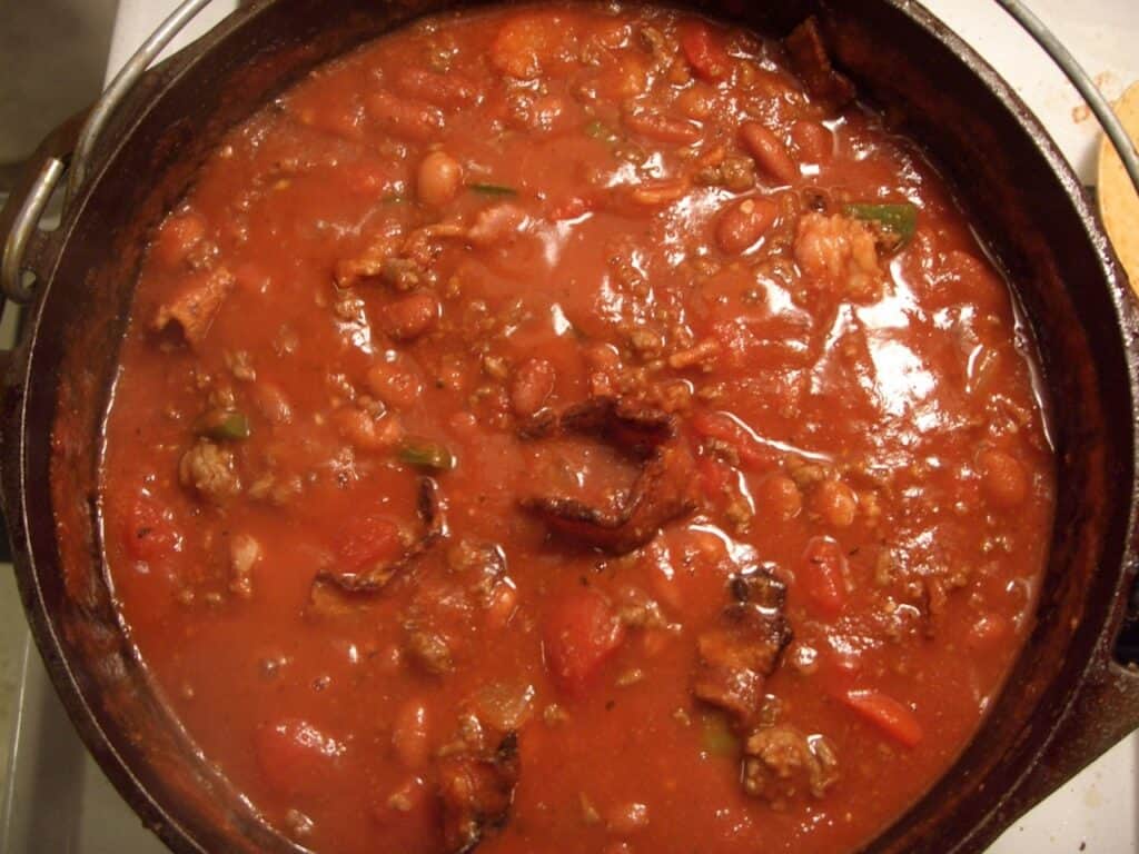 Venison stew in a pot with vegetables and rich broth.