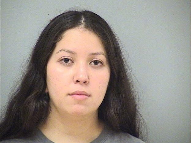Young woman with long dark hair, neutral expression, in a mugshot-style photo.