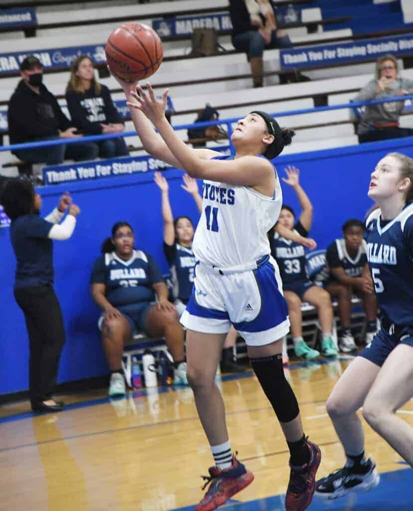 Photo - Madera’s Rhynne Mitchell drives to the lane to score two of her game-high 28 points in Monday’s comeback win over Bullard.