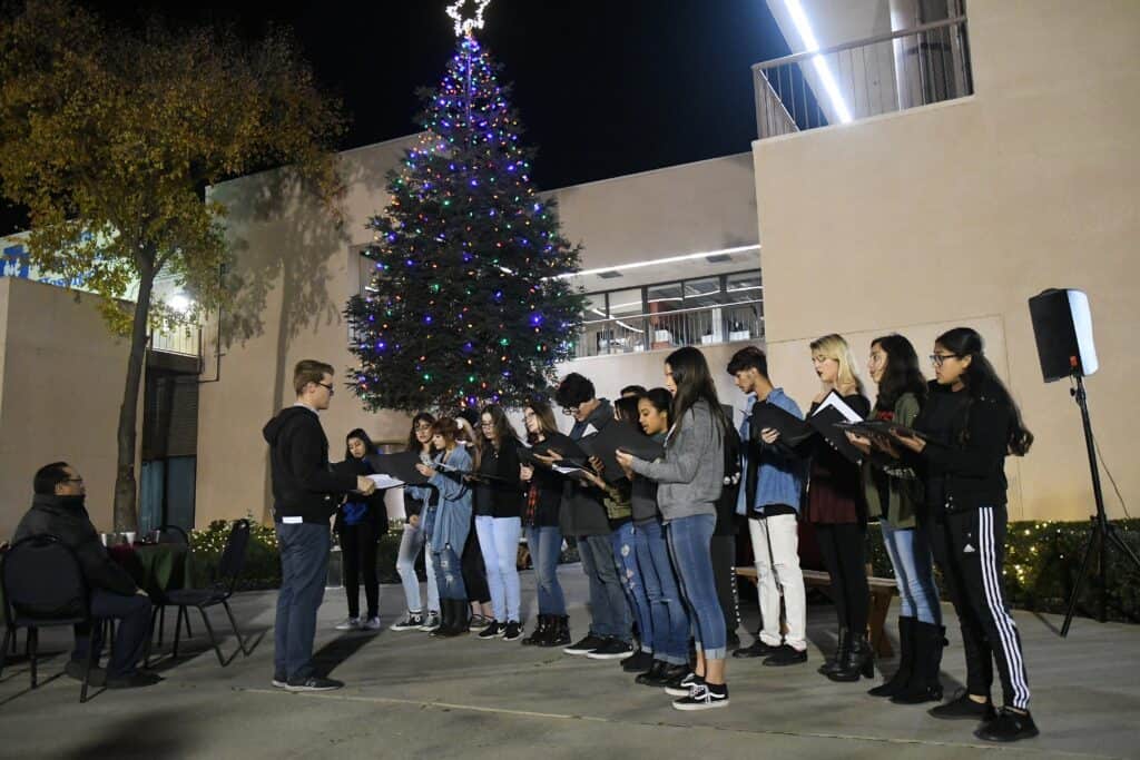 Christmas tree lighting ceremony at the hospital with a choir performing.