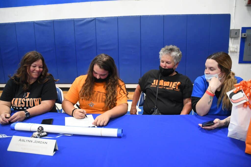 Jordan receiving scholarship after multiple surgeries at Madera event.