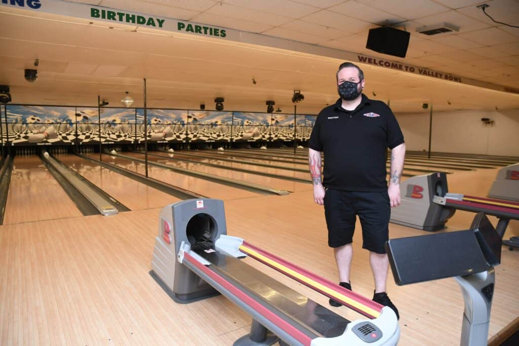 Staff member wearing a mask at Madera bowling alley.