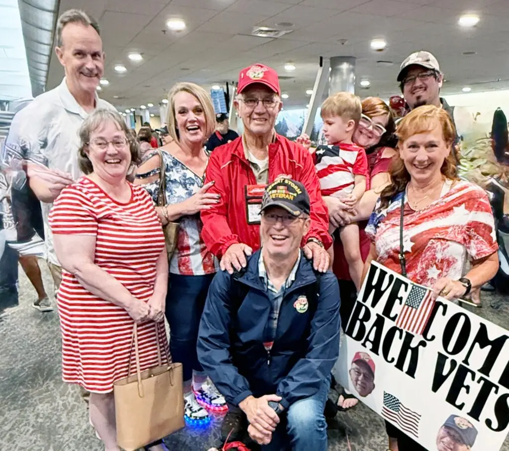 Photo - Richard Smith (center with red jacket) stands with his family at the Fresno Air Terminal after his return from the 32nd Central Honor Flight to Washington, D.C., on September 10.