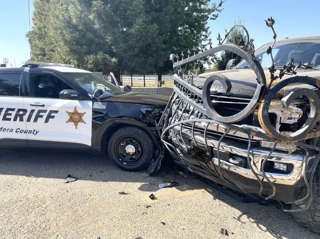 Accident scene showing a sheriff's vehicle and a damaged truck after a collision.