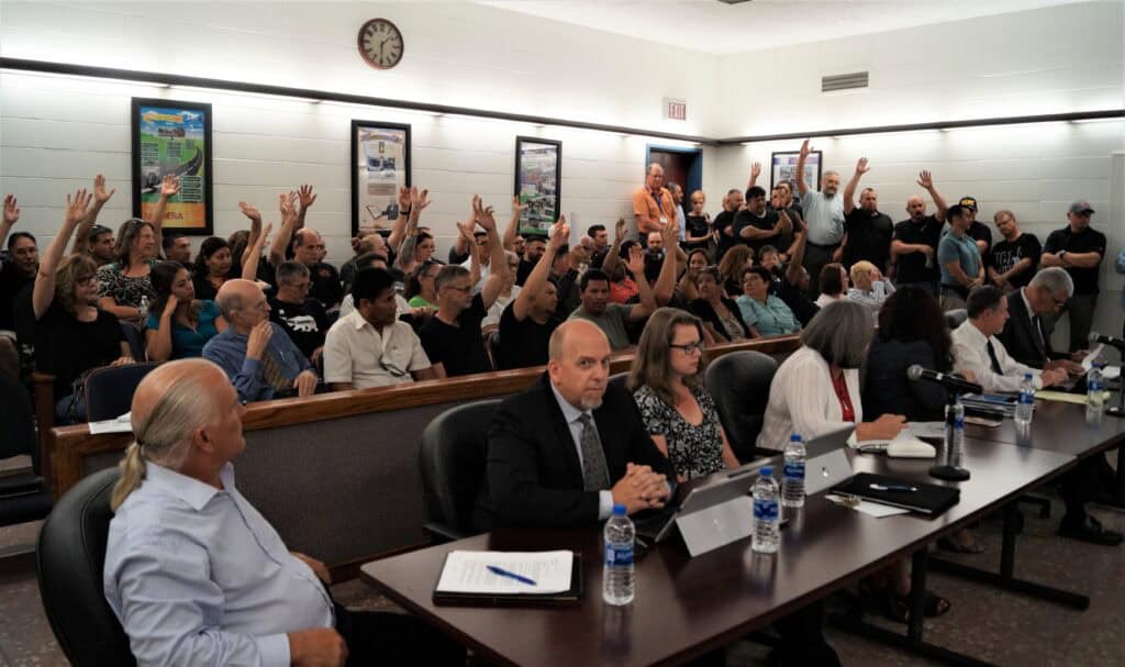 Community members, police, and city workers participate in a public forum.