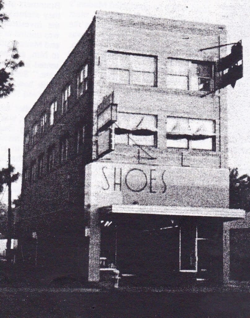 Shoes sign on old building in Madera, showcasing innovative retail display methods.