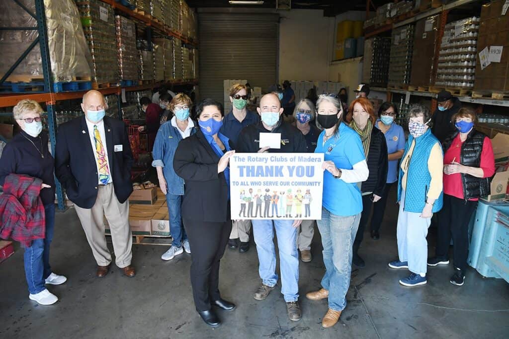 Madera Rotary members celebrating gratitude with community service.