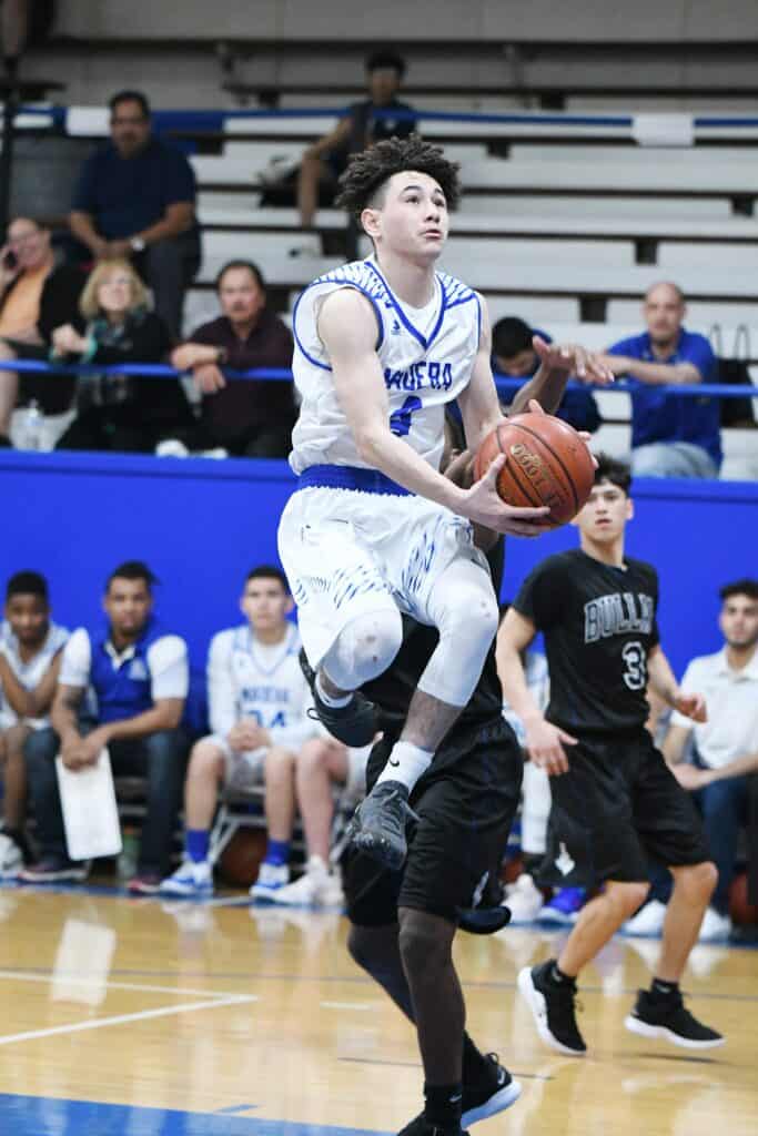 Young basketball player in action during a game at the Madera Tribune event.