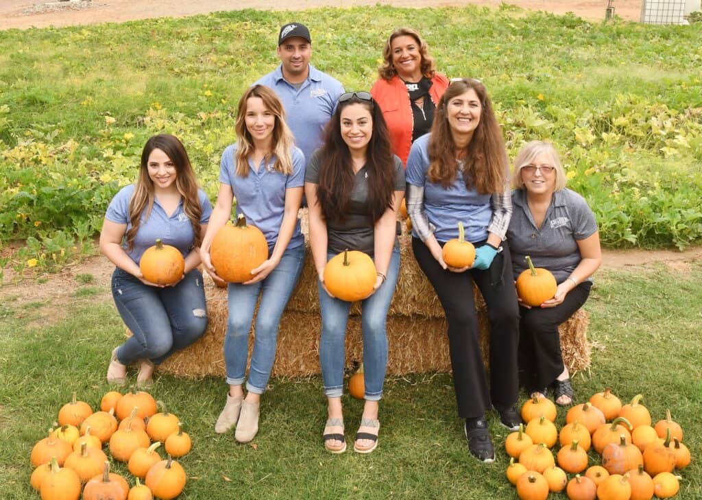 Madera students giving back by harvesting pumpkins at community event.