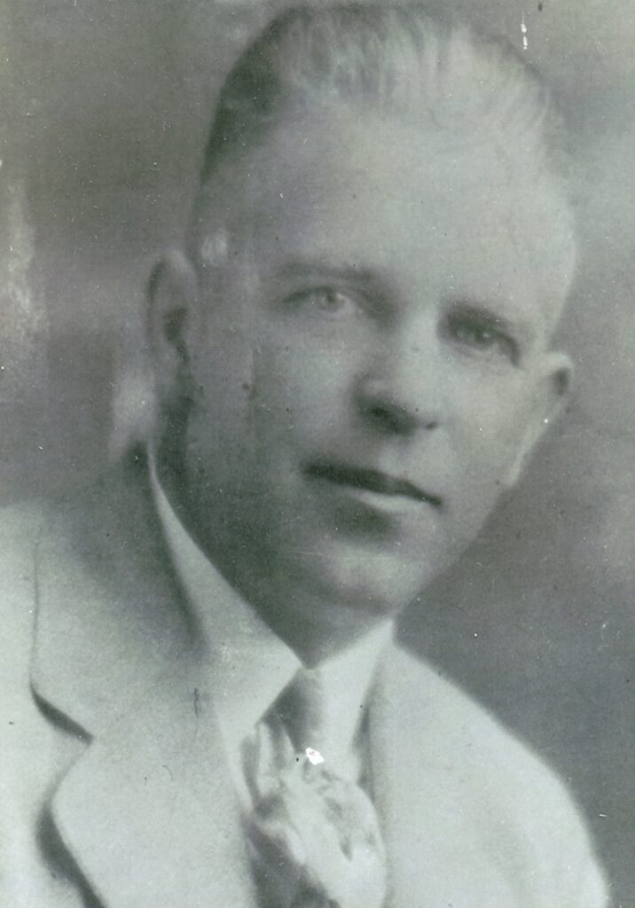 Black and white portrait of a young man in formal attire from Madera Tribune archives.