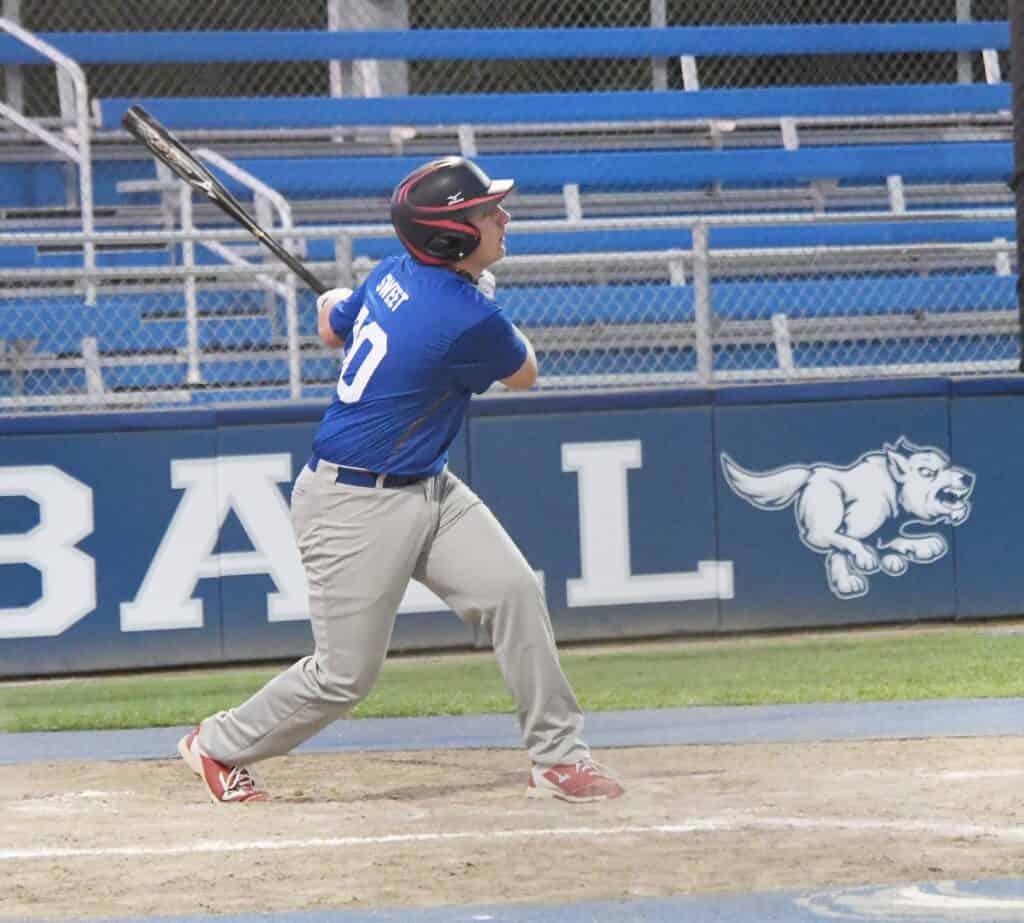 Young baseball player swinging at a pitch during the state title game in Madera.