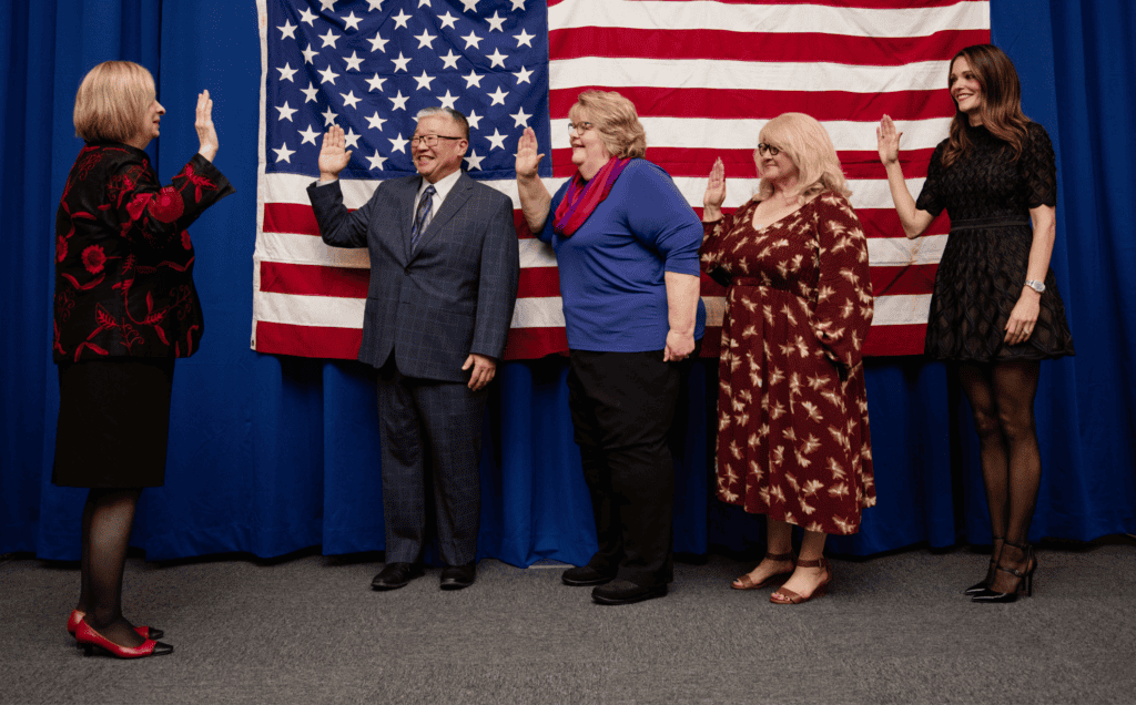 MCSOS board members being inducted during the ceremony with American flag backdrop.