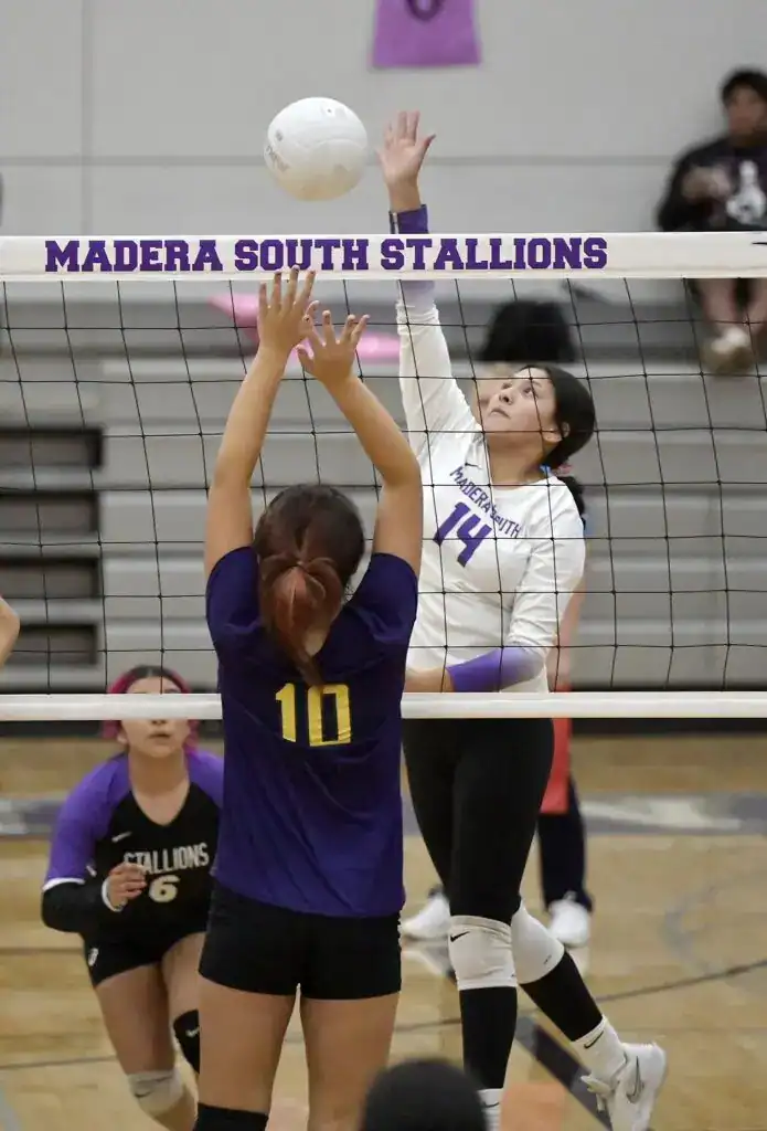Photo - Madera South’s Maria Hernandez sends a cross court kill past the Fresno block during Tuesday’s win. Hernandez put down nine kills in the five-set victory.