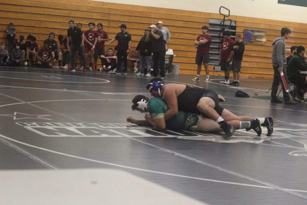 Madera wrestlers competing during a dual meet at the gym.