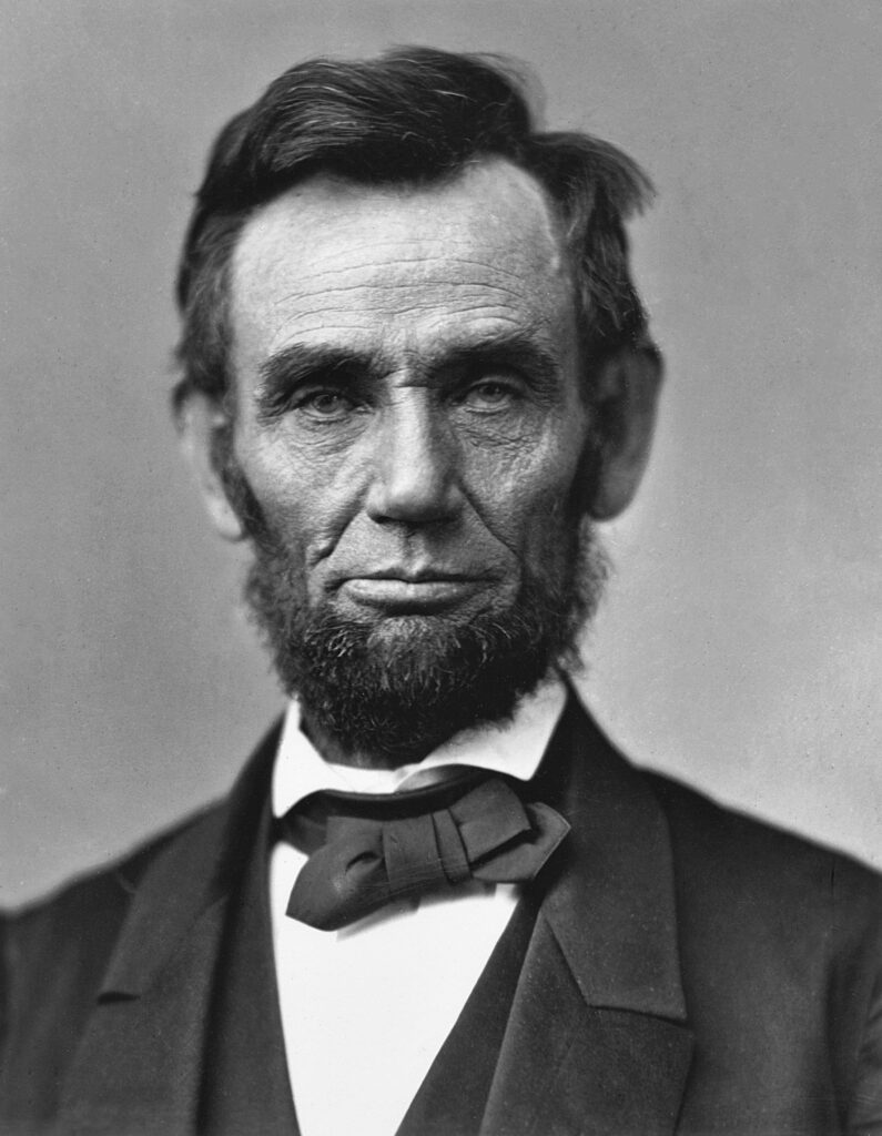 Abraham Lincoln, Civil War president, in a formal suit with bow tie, black and white photo.