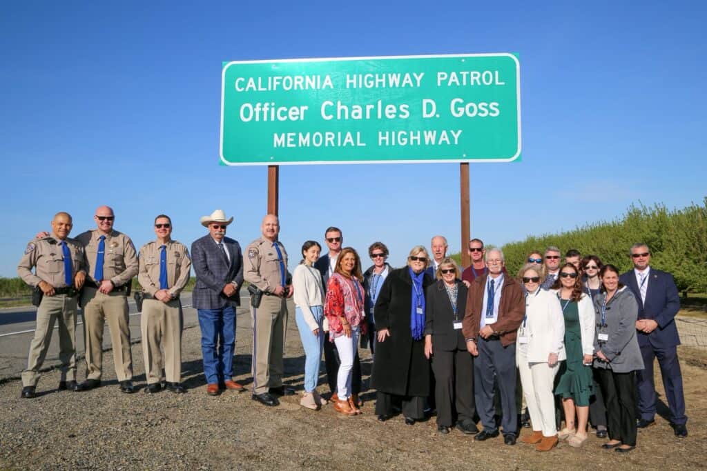 Group of people at the highway dedication for Officer Charles D. Goss Memorial Highway.