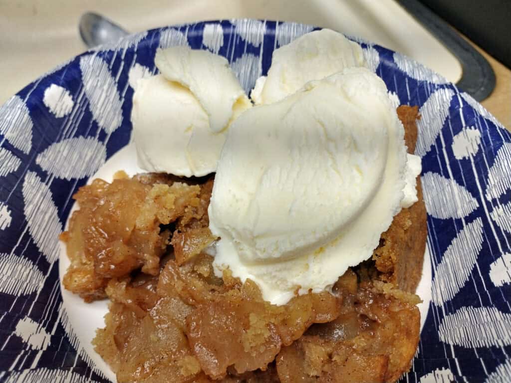 Delicious apple crisp topped with vanilla ice cream, perfect for a fall treat.