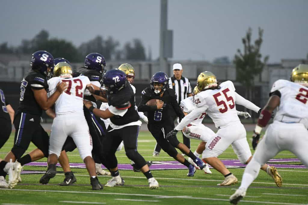 Madera Stallions football players in action during a game.