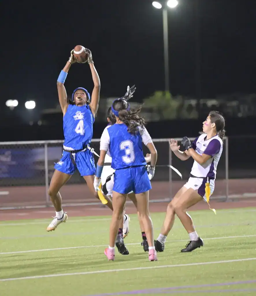 Photo - Madera’s Janyah Spotwood reaches up to catch a conversion pass during Thursday’s 26-0 victory over Madera South.