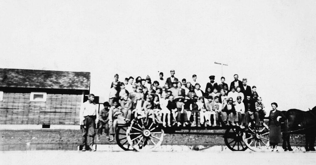 Historic photo of Madera County Fair Parade with vintage car and crowd, 1910.