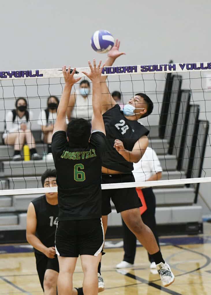 Madera South volleyball player spikes the ball during a match.