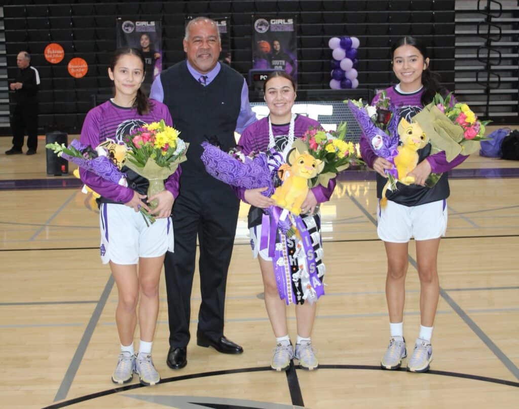 Senior girls basketball players with coach on Sr. Night event.