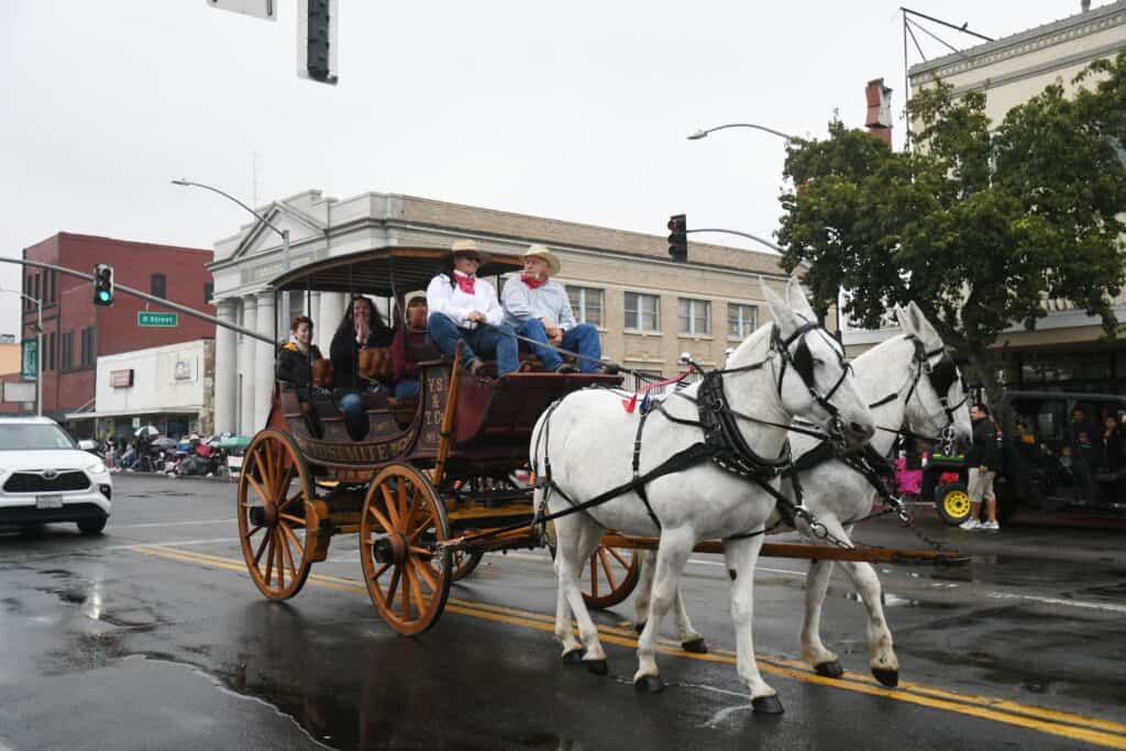 Old Timers’ Day parade with horse-drawn carriage in Madera, celebrating community heritage.