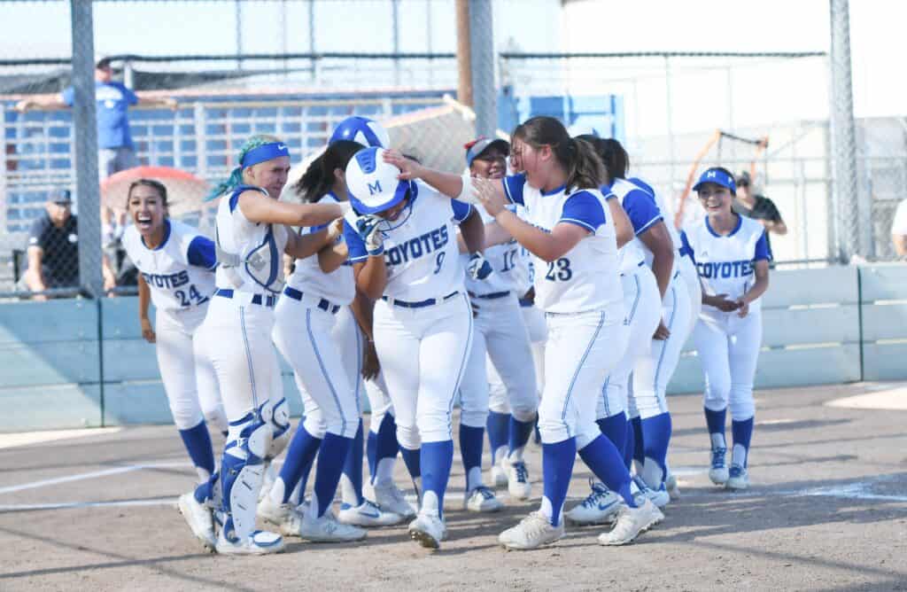 Madera Coyotes softball team celebrating after winning CMAC title.