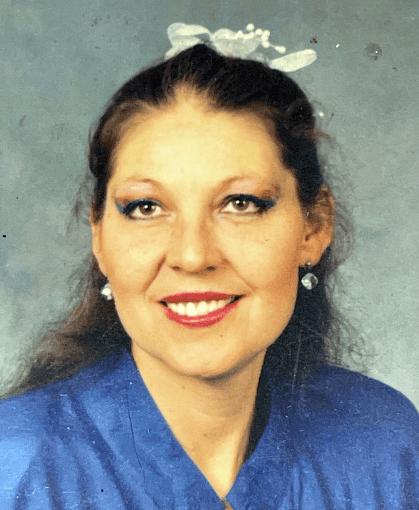 Dora Short-Robertson, featured in The Madera Tribune obituary, smiling in a blue dress.