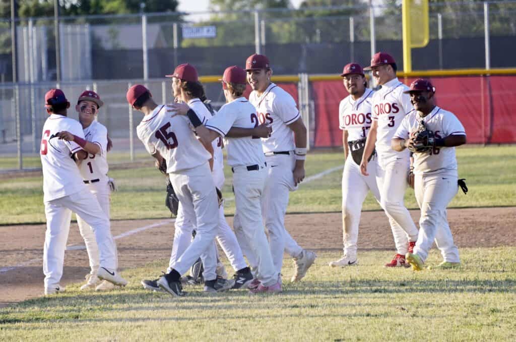 Madera baseball players celebrating after winning game against Chieftains.
