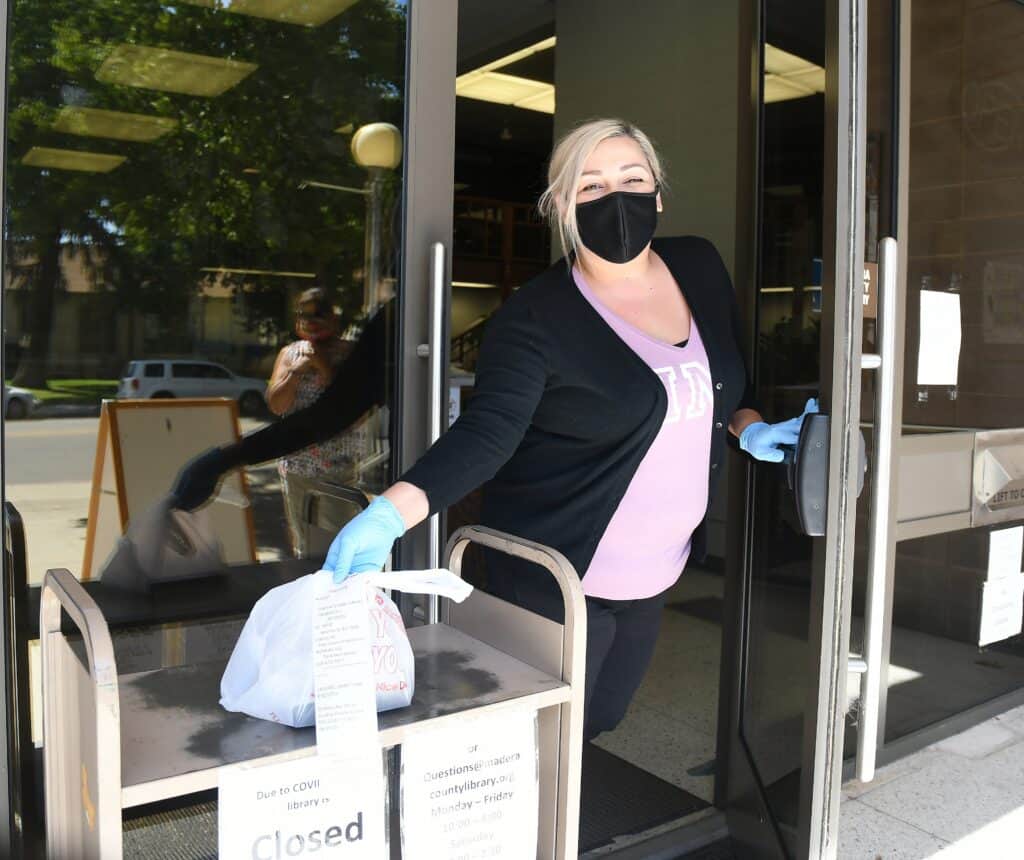 Curbside library service at Madera Libraries offers contactless book pickup during ongoing health pr.