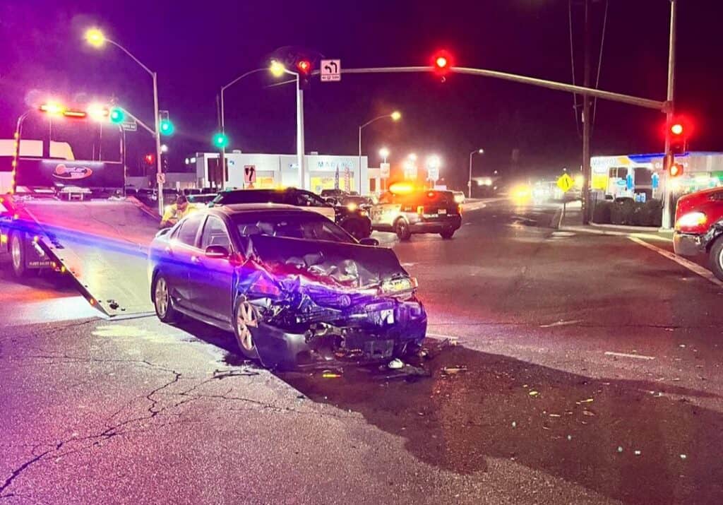 Photo - A car sits in the middle of the intersection of Madera Avenue at State Route 99 after an illegal U-turn resulted in a three-vehicle crash.