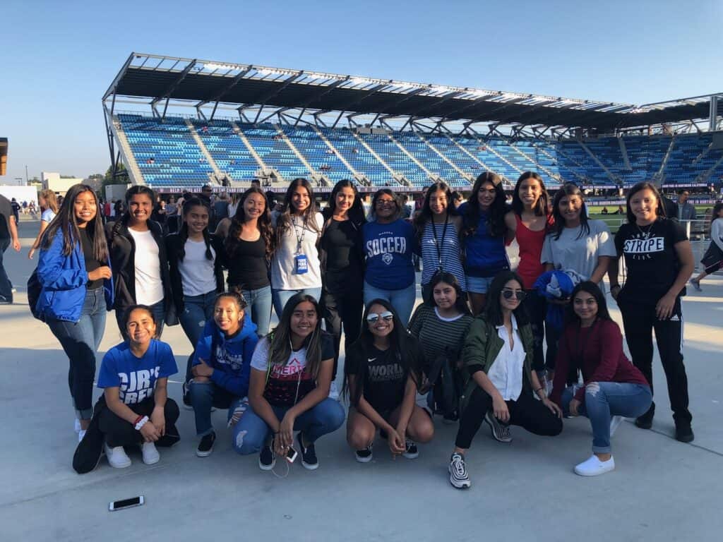 Group of young soccer fans at the stadium watching USA defeat Chile.