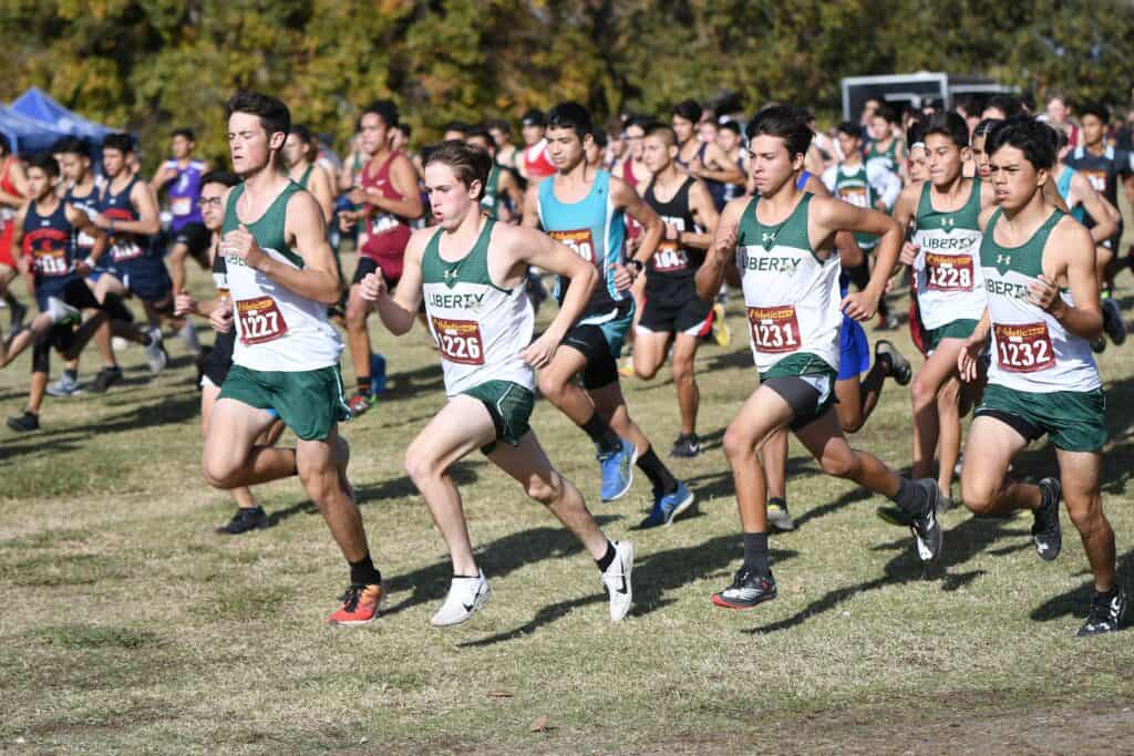 Photo - The Liberty Hawks boys cross country team will opened its season Friday with a dual meet at the school, beginning in the stadium.