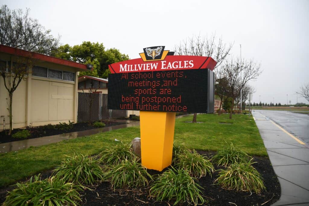 Millview Eagles school sign with postponed events notice.