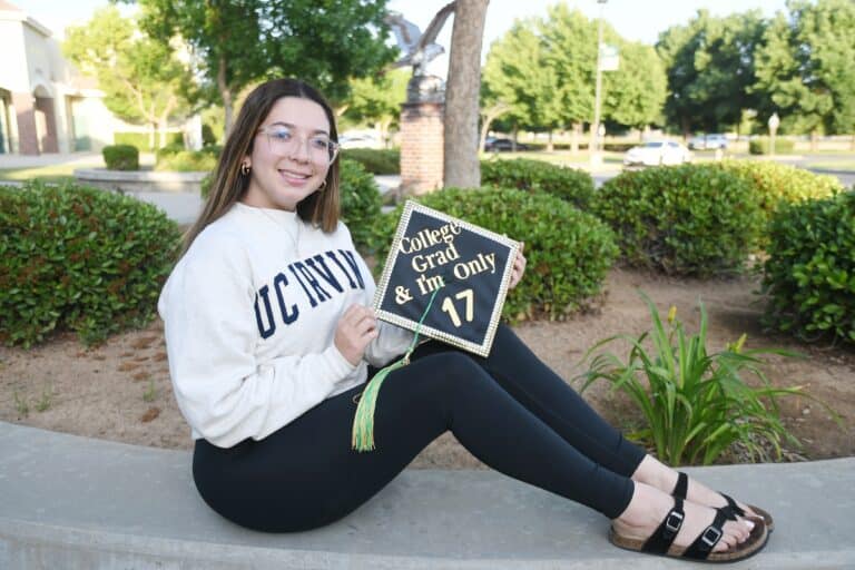 Liberty senior graduates with 2 diplomas