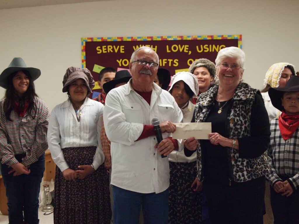 Community members celebrate a gift presentation at the Historical Society event.