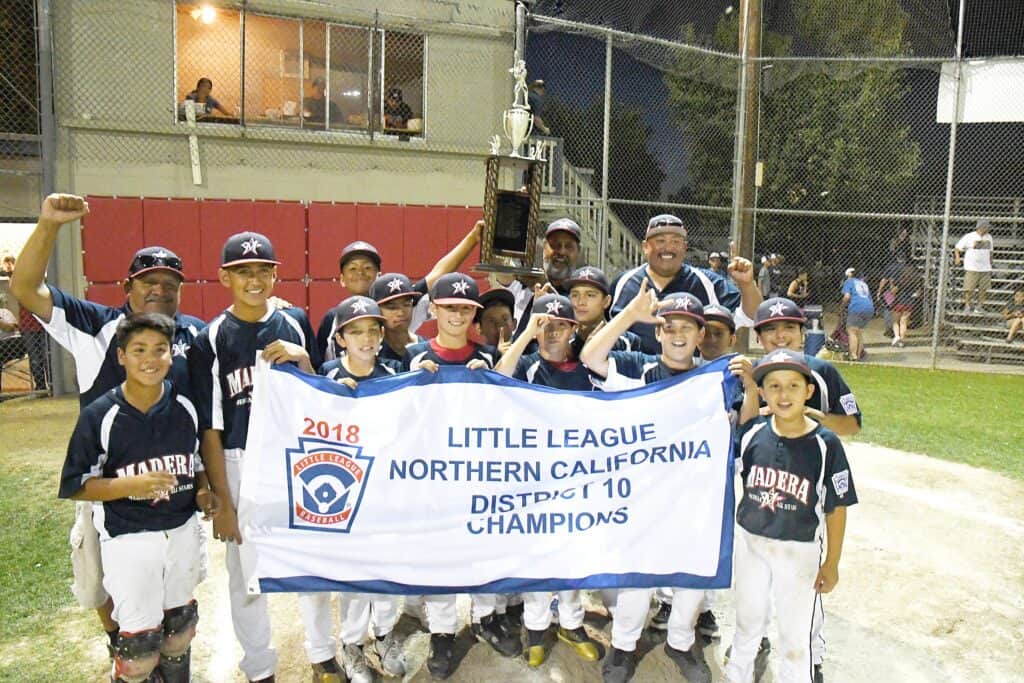 Madera Little League team celebrating District 10 championship victory.