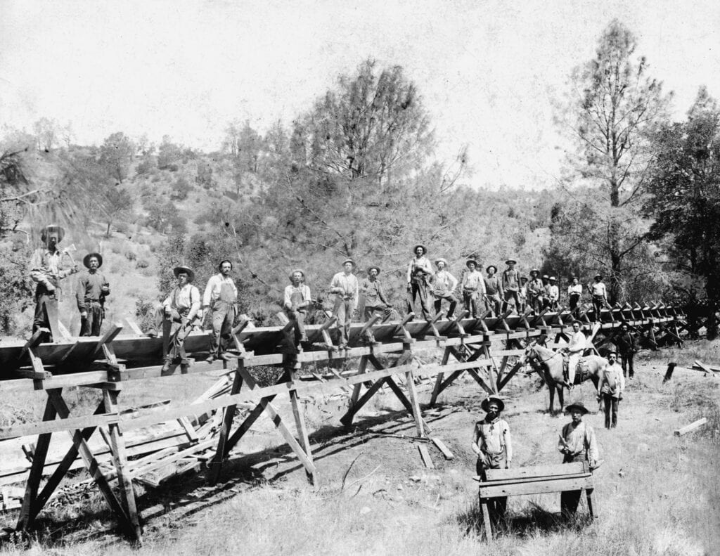 Historic photo of lumber workers building a bridge in Madera.