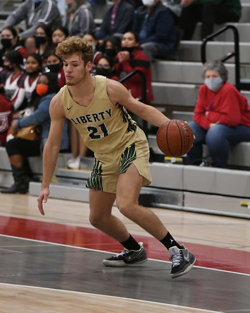 Young male basketball player dribbling during a game at All-Tribune Boys Basketball event.