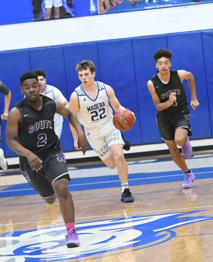 Madera Coyotes basketball players in action during a game.