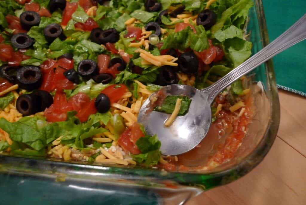 Fresh Mexican-inspired salad with lettuce, tomatoes, olives, and cheese.