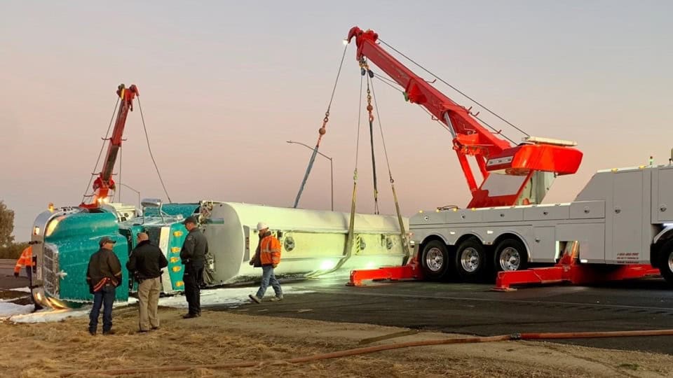 Gas tanker crashes on SR99, emergency crews respond with crane to upright the vehicle.