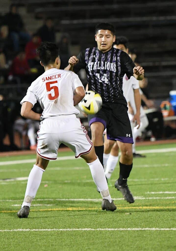 Youth soccer players competing during a match at Madera Tribun event.