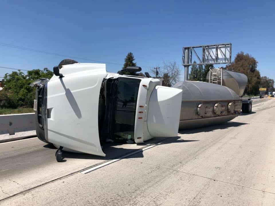 Semi overturned on SR99 causing traffic delays and road closure.