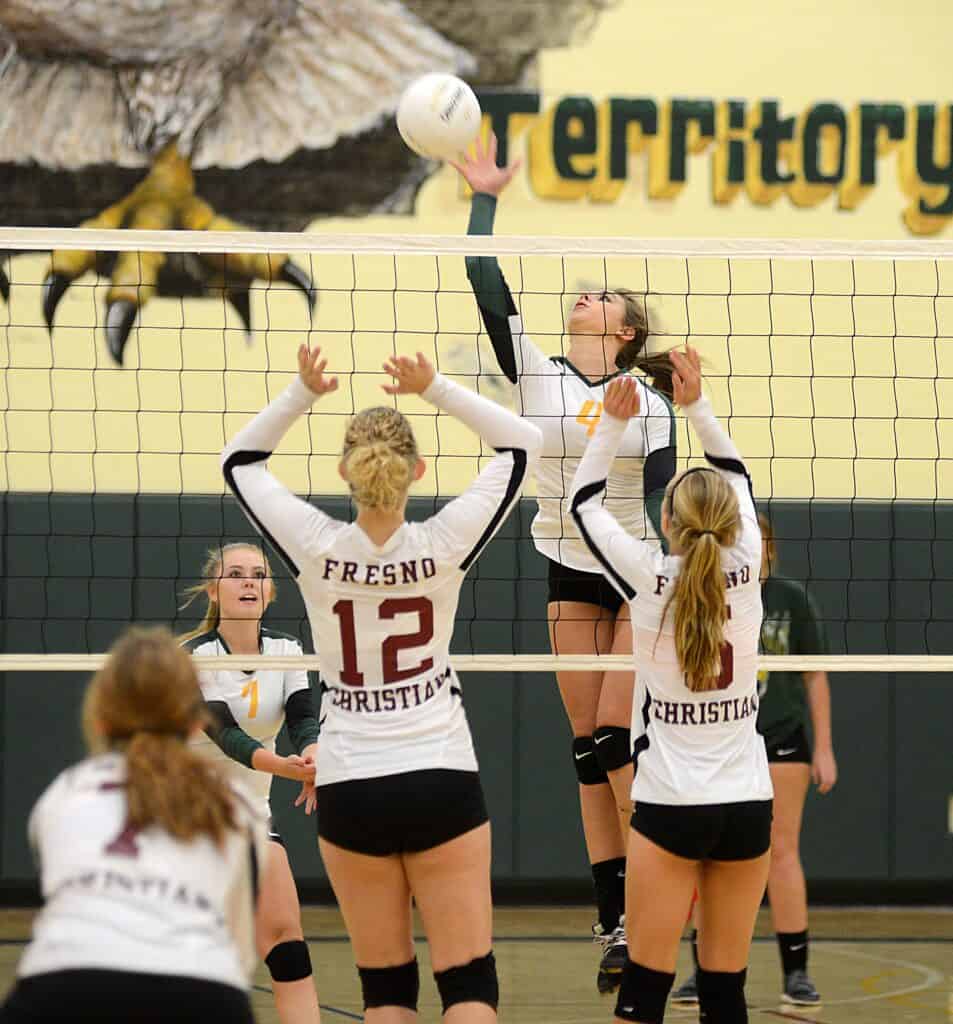 Girls volleyball match at Madera high school gym during a game.