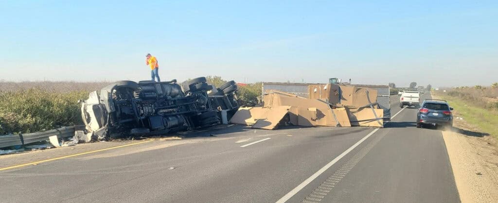Semi overturned blocking SR99 causing traffic snarls.